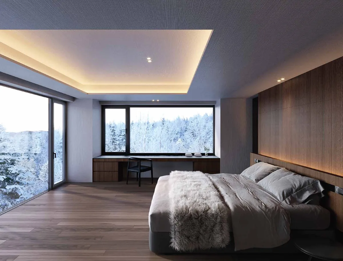 Bedroom with picture window onto snowy forest