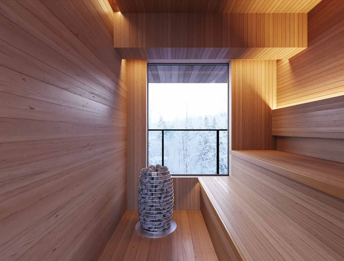 Sauna room with a window onto snowy trees