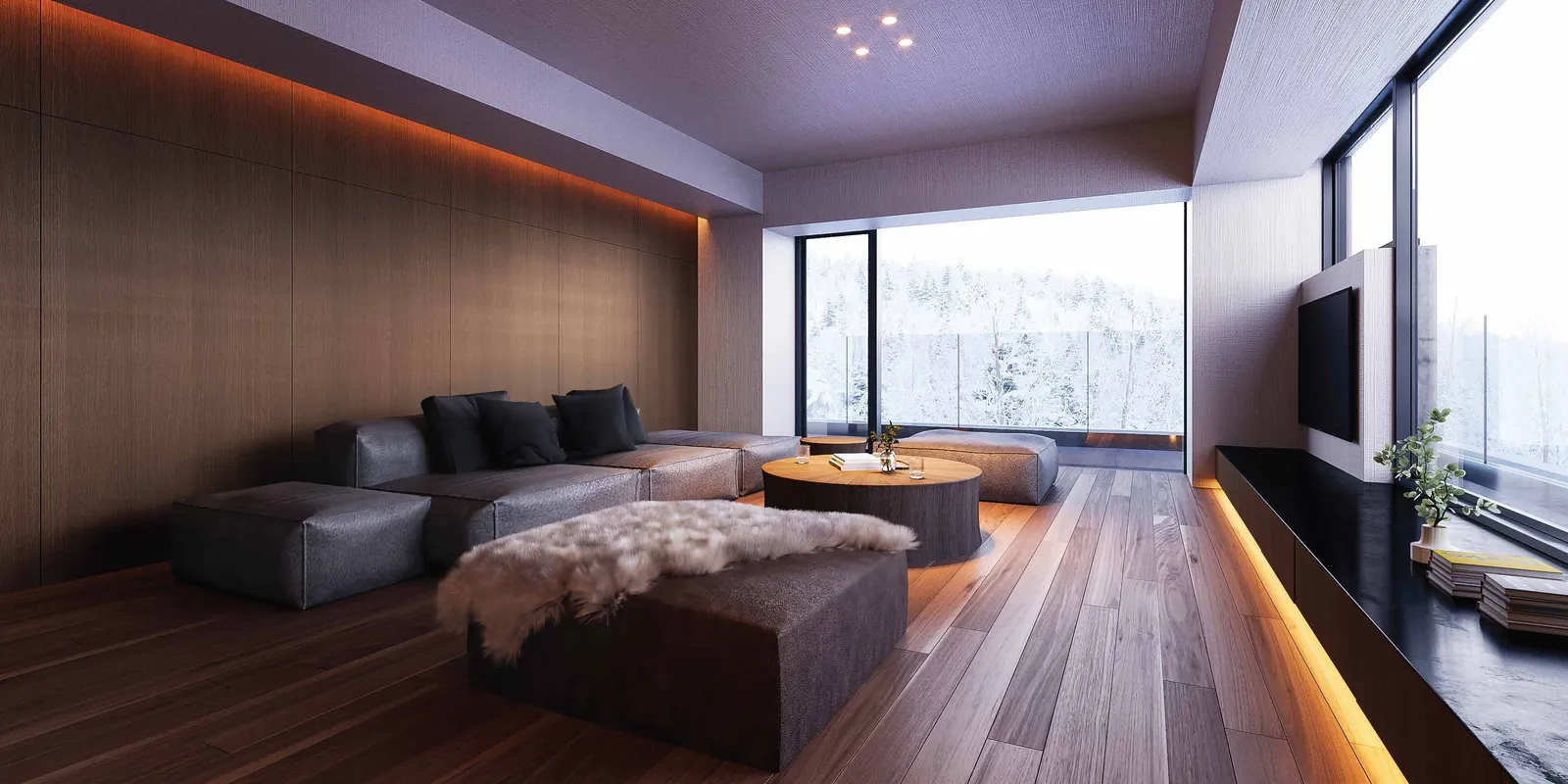 Living room of a Signature Residence with floor-to-ceiling windows onto snowy forest